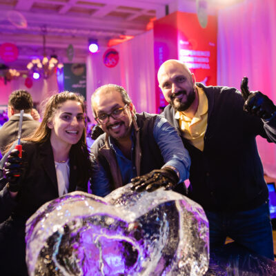 A group proudly showcases their completed ice sculpture during a Team building Ice Sculpting event, celebrating their teamwork and creativity. thumbnail