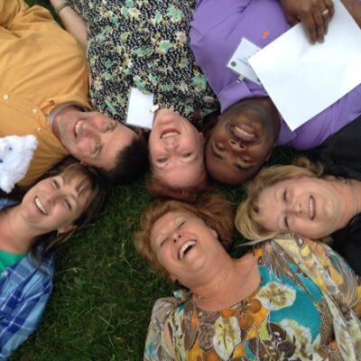 Employees having fun lying in the grass thumbnail