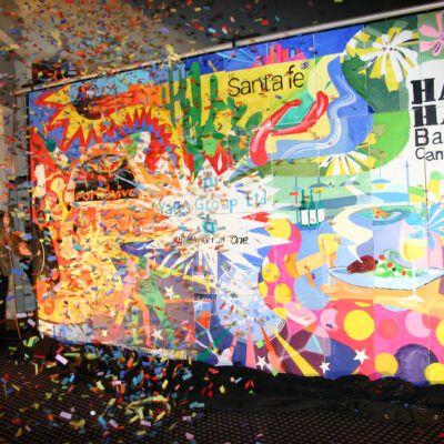 A vibrant mural is unveiled with a burst of confetti during The Big Picture team building event, celebrating collaboration and creativity. thumbnail