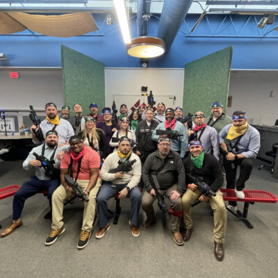 Team poses for a group photo after an action-packed laser tag session during The Mystery Bus team building event, creating unforgettable memories. thumbnail
