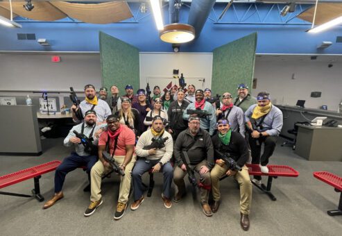 Team poses for a group photo after an action-packed laser tag session during The Mystery Bus team building event, creating unforgettable memories.