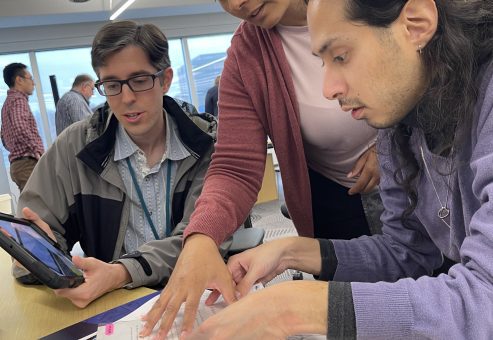 Team reviews case files and clues to solve the mystery during the Corporate CSI team building event.