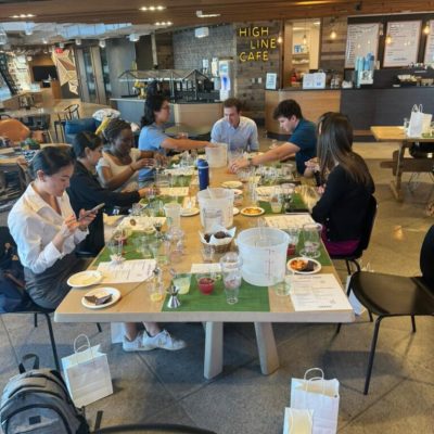 Team gathered around a table during a mixology class, crafting cocktails and enjoying the experience together. The interactive event fosters collaboration, creativity, and camaraderie in a relaxed setting. thumbnail