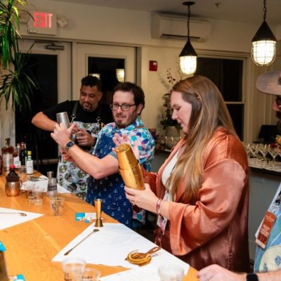 Team members shaking up cocktails during a mixology class. This fun and interactive team building event encourages collaboration, creativity, and the art of crafting delicious drinks. thumbnail