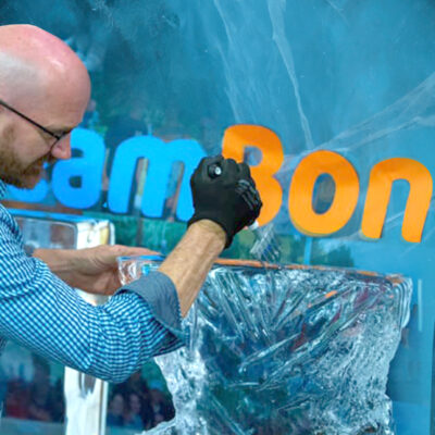 A participant works on an ice sculpture while taking part in a Team building Ice Sculpting event, showcasing creativity and teamwork. thumbnail